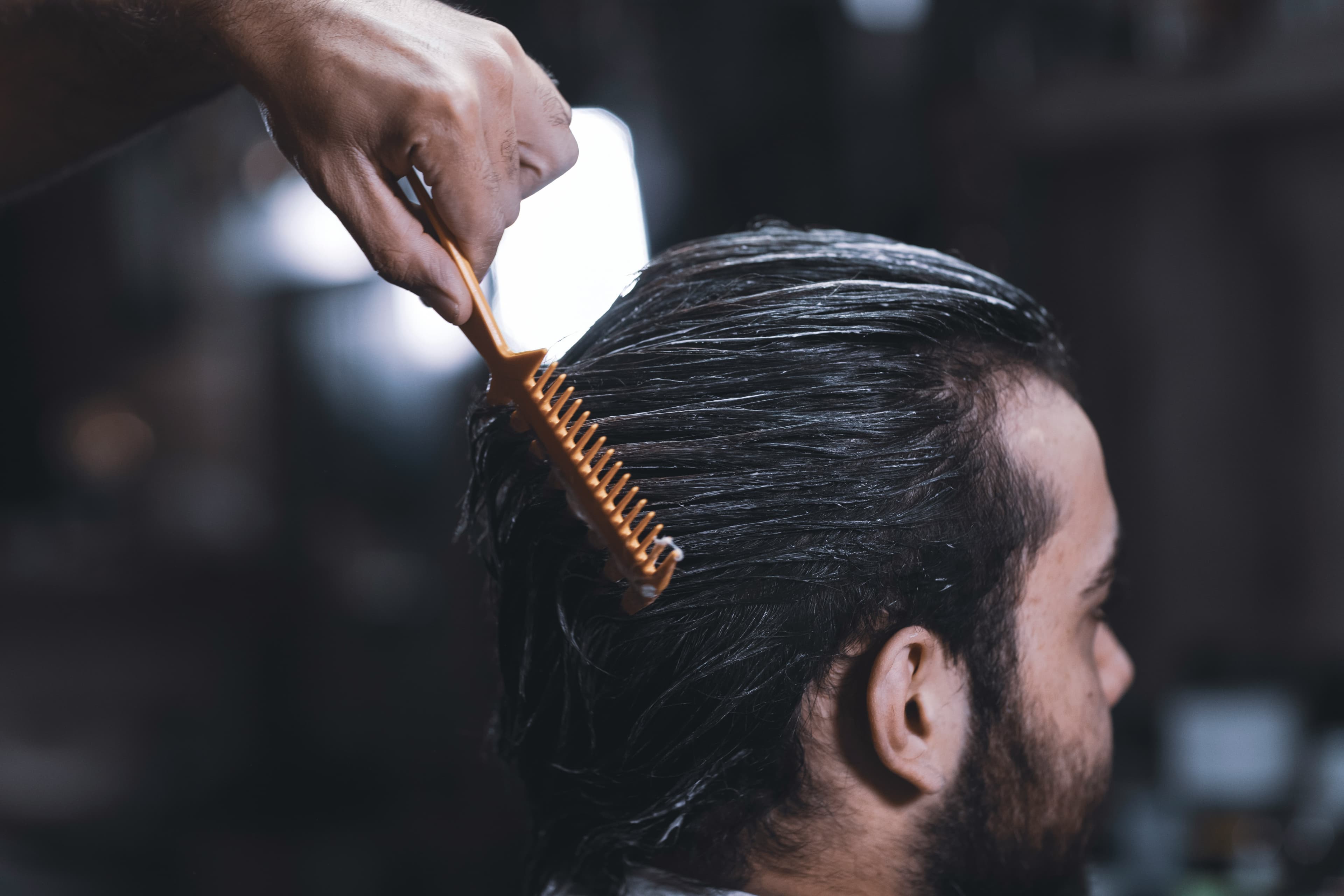 Barber combing a client's hair